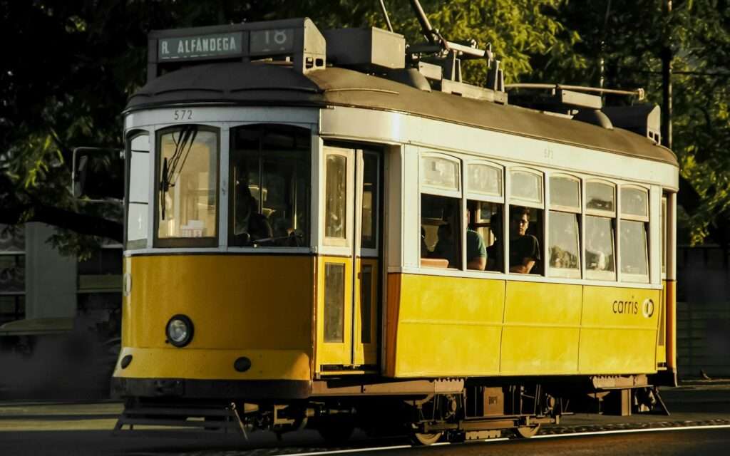 A classic yellow Lisbon tram in golden evening light