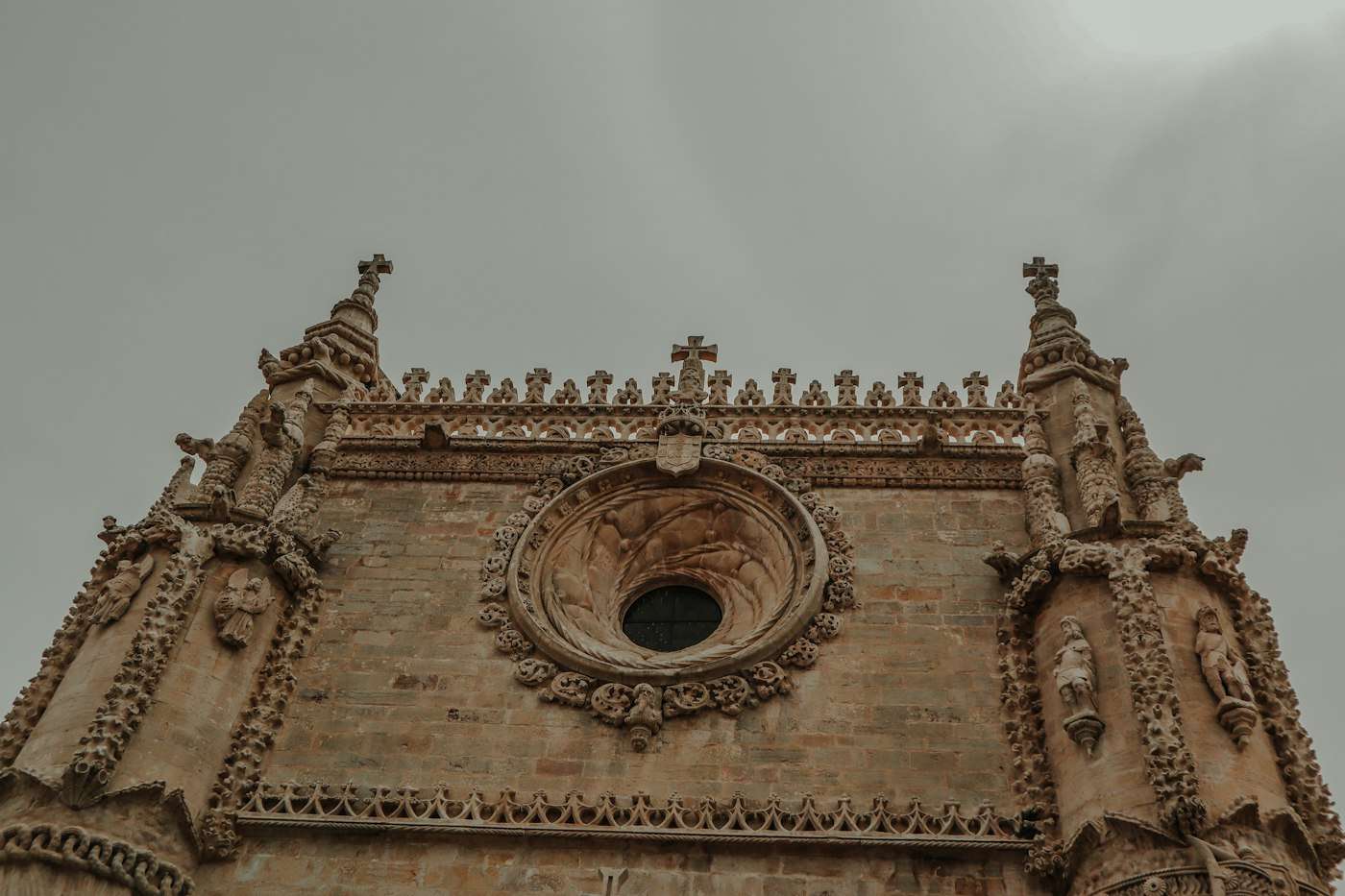 Carved pinnacles and the round window of the Convent of Christ in Tomar